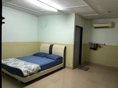 a bedroom with a bed with blue sheets and a ceiling at Villa Warisan Homestay