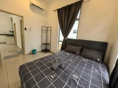 a bedroom with a bed with a stuffed animal on it at Padang Serai Wangi Homestay 95 in Padang Serai
