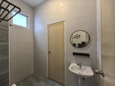 a bathroom with a sink and a mirror at Padang Serai Wangi Homestay 95 in Padang Serai