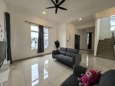 a living room with a couch and a stuffed animal at Padang Serai Wangi Homestay 95 in Padang Serai