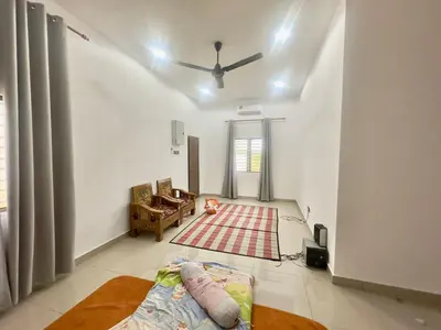 a living room with a bed and a ceiling fan at homestay juliana rinching tengah in Gua Sai