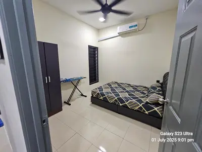 a bedroom with a bed and a ceiling fan at Homestay ZAF sitiawan in Sitiawan