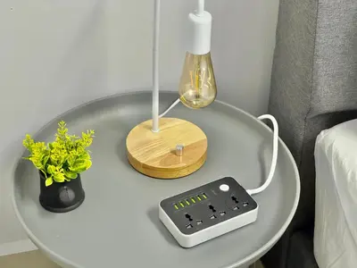 a table with a scale and a lamp on it at Spacious 2 Storey Homestay Tanjung Bungah 25Pax by 3C in Tanjung Bungah