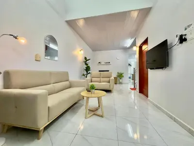 a living room with a couch and a tv at Spacious 2 Storey Homestay Tanjung Bungah 25Pax by 3C in Tanjung Bungah