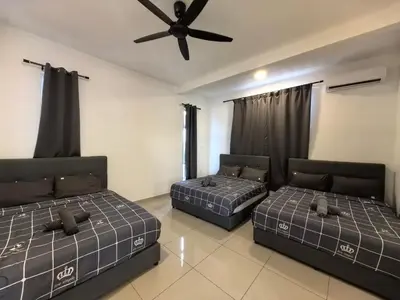 two beds in a room with a ceiling fan at Padang Serai Wangi Roomstay 95 in Padang Serai