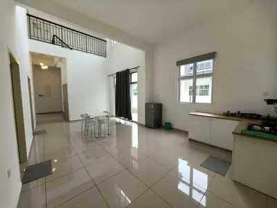 a large white room with a kitchen and a table at Padang Serai Wangi Roomstay 95 in Padang Serai