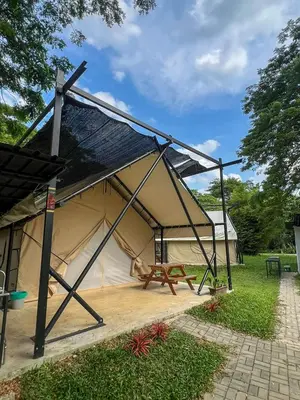 a tent with a picnic table inside of it at Glamping at Xscape Tambun in Ipoh