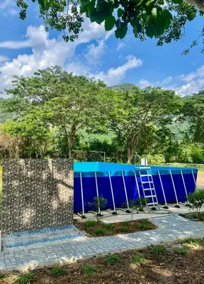 a blue building with a ladder in front at Glamping at Xscape Tambun in Ipoh