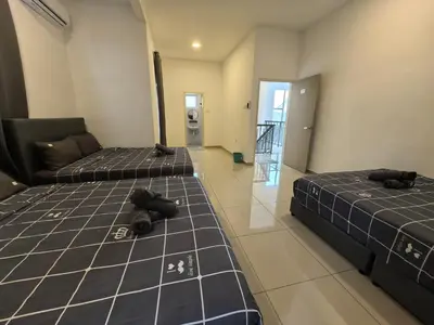 two beds sitting in a room with a hallway at Family Room with Private Bathroom in Padang Serai