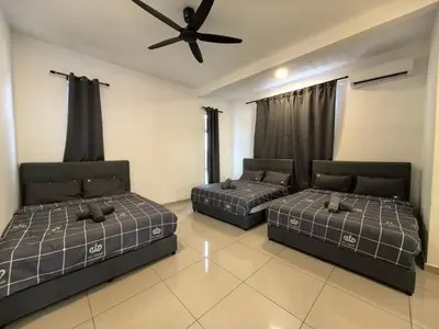 two beds in a room with a ceiling fan at Family Room with Private Bathroom in Padang Serai