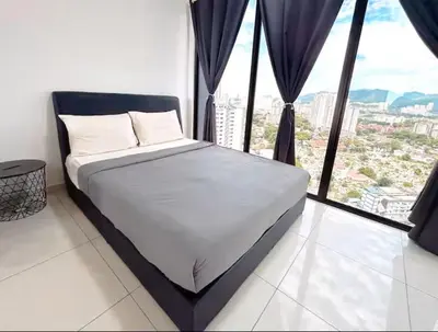 a bed in a room with a large window at Beacon #2BR FamilyStay #22Georgetown in George Town