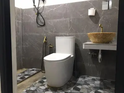 a bathroom with a toilet and a sink at As Sufi Village in Kampung Sungai Air Tawar