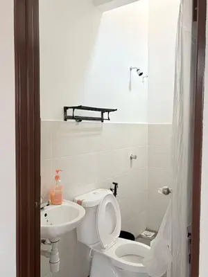 a white bathroom with a toilet and a sink at Homestay Taman Scientex Kota Tinggi in Gua Sai