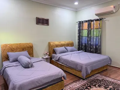 two beds sitting next to each other in a room at SkyView Village Ulu Chemor in Chemor