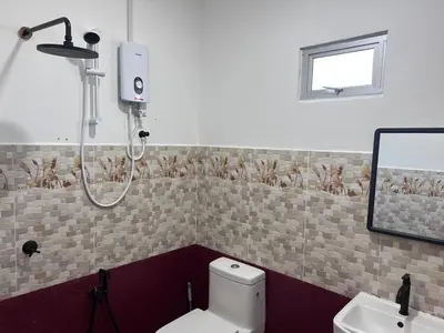 a bathroom with a shower and a toilet and a sink at SkyView Village Ulu Chemor in Chemor
