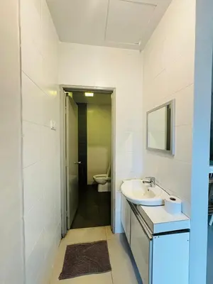a white bathroom with a sink and a toilet at Kareena Barrington Square Goldenhills Pasar Malam Cameron Highlands in Brinchang