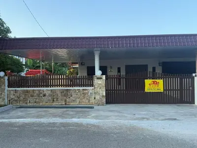 a building with a fence with a sign on it at Happy Guest House Taman Cowin Nibong Tebal \u5f00\u5fc3\u6c11\u5bbfTaman Cowin\u9ad8\u6e0a\u533a in Nibung Tebal