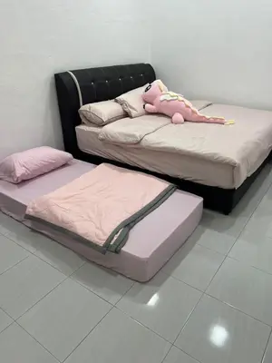two beds with a teddy bear on top of them at Happy Guest House Taman Cowin Nibong Tebal \u5f00\u5fc3\u6c11\u5bbfTaman Cowin\u9ad8\u6e0a\u533a in Nibung Tebal