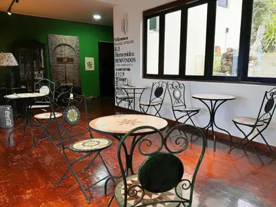 a room with tables and chairs in a room at VELAMUNDi INN Batu Ferringhi in Batu Ferringhi