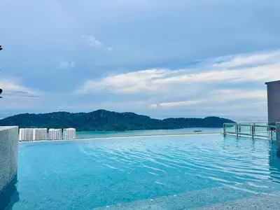 a swimming pool with a view of the ocean at Sky Pool Luxury Stay Sea View Bayan Airport in Bayan Lepas