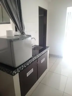 a kitchen with a sink and a counter top at Marina sunset view in Lumut