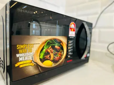 a microwave oven with a picture of a soup in it at CozyStay Rooftop Sky Pool Sea &Bridge View Luxury 9pax in Bayan Lepas