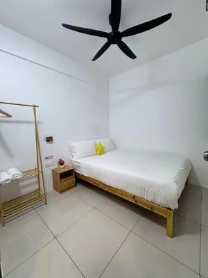 a bedroom with a bed with a ceiling fan at Manhattan Condominium Ipoh' Rachel in Ipoh