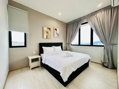 a bedroom with a large bed and two windows at New LuxurySuite Rooftop Pool Stunning View airport 9pax in Bayan Lepas