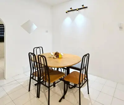 a wooden table and chairs in a room at Blue House Kampar 3BR Family Suite-Kids Playroom Near UTAR in Kampar