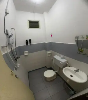 a bathroom with a toilet and a sink at Homestay Dmickey in Sungai Petani