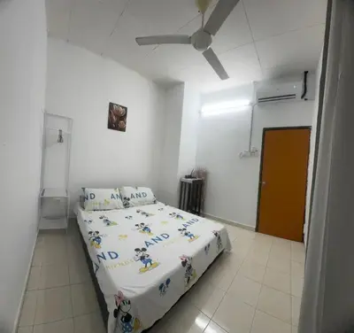 a bedroom with a bed and a ceiling fan at Homestay Dmickey in Sungai Petani