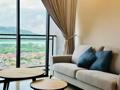 a living room with a couch and a large window at Sea Bridge View Sky Pool Cozy 3BR Retreat airport 9pax in Bayan Lepas