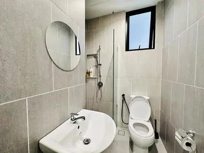 a bathroom with a toilet and a sink and a mirror at Sea Bridge View Sky Pool Cozy 3BR Retreat airport 9pax in Bayan Lepas