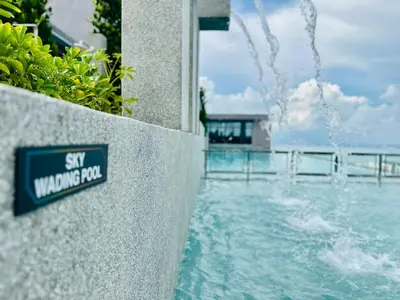 a sign on a wall next to a swimming pool at Iconic Regency bayan lepas 42 skypool airport usm 9pax in Bayan Lepas