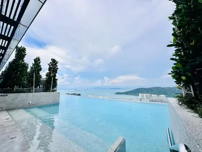 a swimming pool with a view of the water at Sky Pool Luxury Sea View Near Penang Airport 9pax in Bayan Lepas