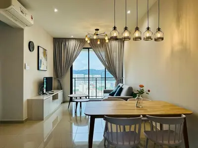 a dining room and living room with a table and chairs at Sky Pool Luxury Sea View Near Penang Airport 9pax in Bayan Lepas