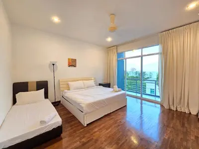 a bedroom with two beds and a large window at Shamrock Beach Villas - Batu Ferringhi in Tanjung Bungah