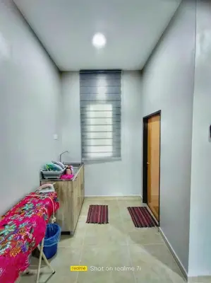 a room with a bed and a desk and a window at Inapan Tepi Sawah