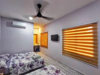 a bedroom with a bed and a window with a tv at Inapan Tepi Sawah