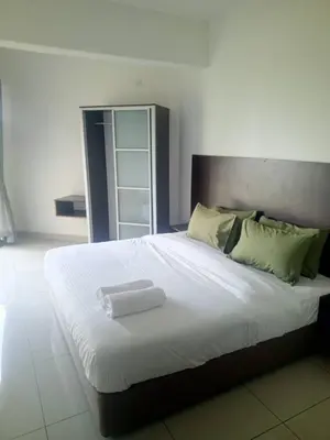 a large white bed with a white tray on it at Marina sunset view in Lumut