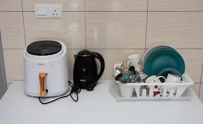 a kitchen counter with a coffee maker and dishes at Serene Japandi Family Retreat 2-6 pax& Sunrise View in Brinchang