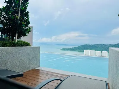 a swimming pool with a view of the ocean at Premium Comfort Rooftop View bayan lepas airport 9pax in Bayan Lepas