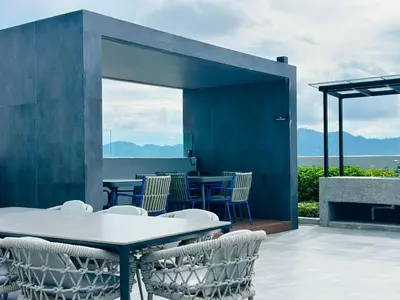 a patio with a table and chairs with a view at High Rise Haven 3BR Rooftop Pool Stylish Comfort 9pax in Bayan Lepas