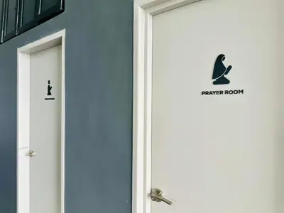 a door with a penguin sign on the side of a building at High Rise Haven 3BR Rooftop Pool Stylish Comfort 9pax in Bayan Lepas