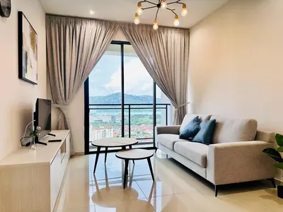 a living room with a couch and a large window at High Rise Haven 3BR Rooftop Pool Stylish Comfort 9pax in Bayan Lepas