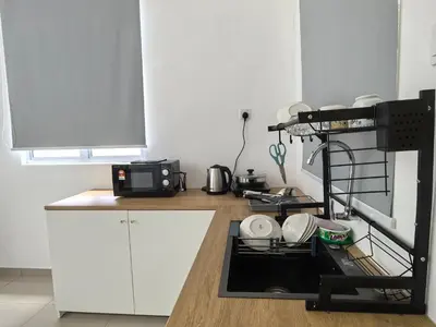 a kitchen with white cabinets and a dishwasher at Padang Serai Wangi Roomstay 91 in Padang Serai