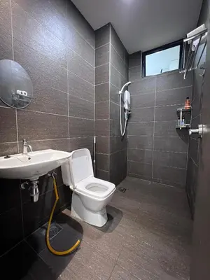 a bathroom with a toilet and a sink at Kuching Town Area Rex apartment in Gua Sai