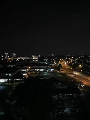 a view of a city at night with lights at Kuching Town Area Rex apartment in Gua Sai