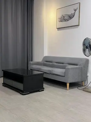 a living room with a couch and a coffee table at Kuching Town Area Rex apartment in Gua Sai