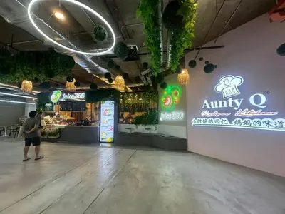 a man is standing in a food court with an entry sign at Spacious Chill Entire Suites 118Island Plaza in George Town